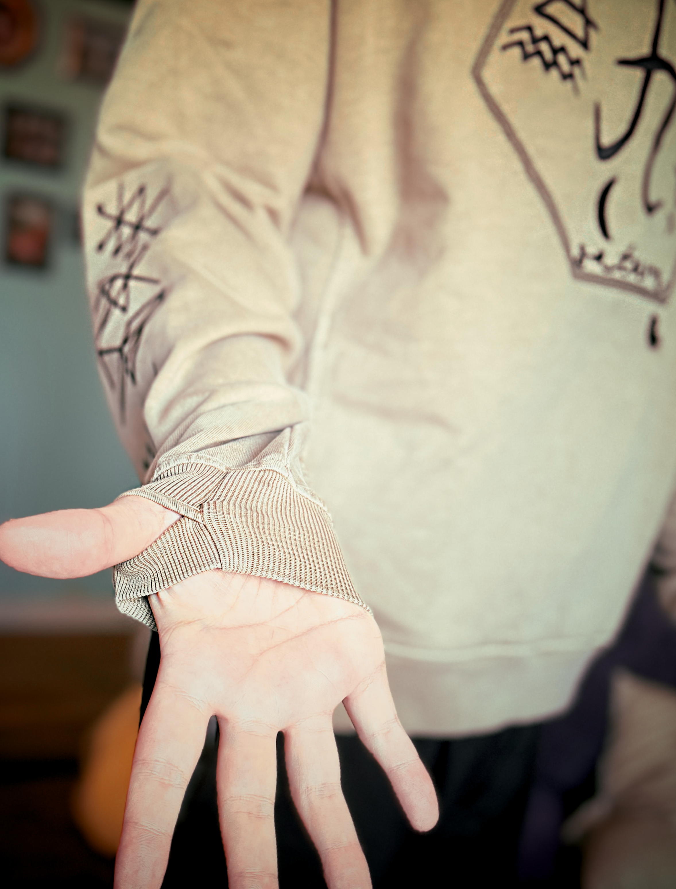 Saturn Stars Embroidered Hoodie worn – sleeve detail showing planetary sigil embroidery, Bouncing Soaps
