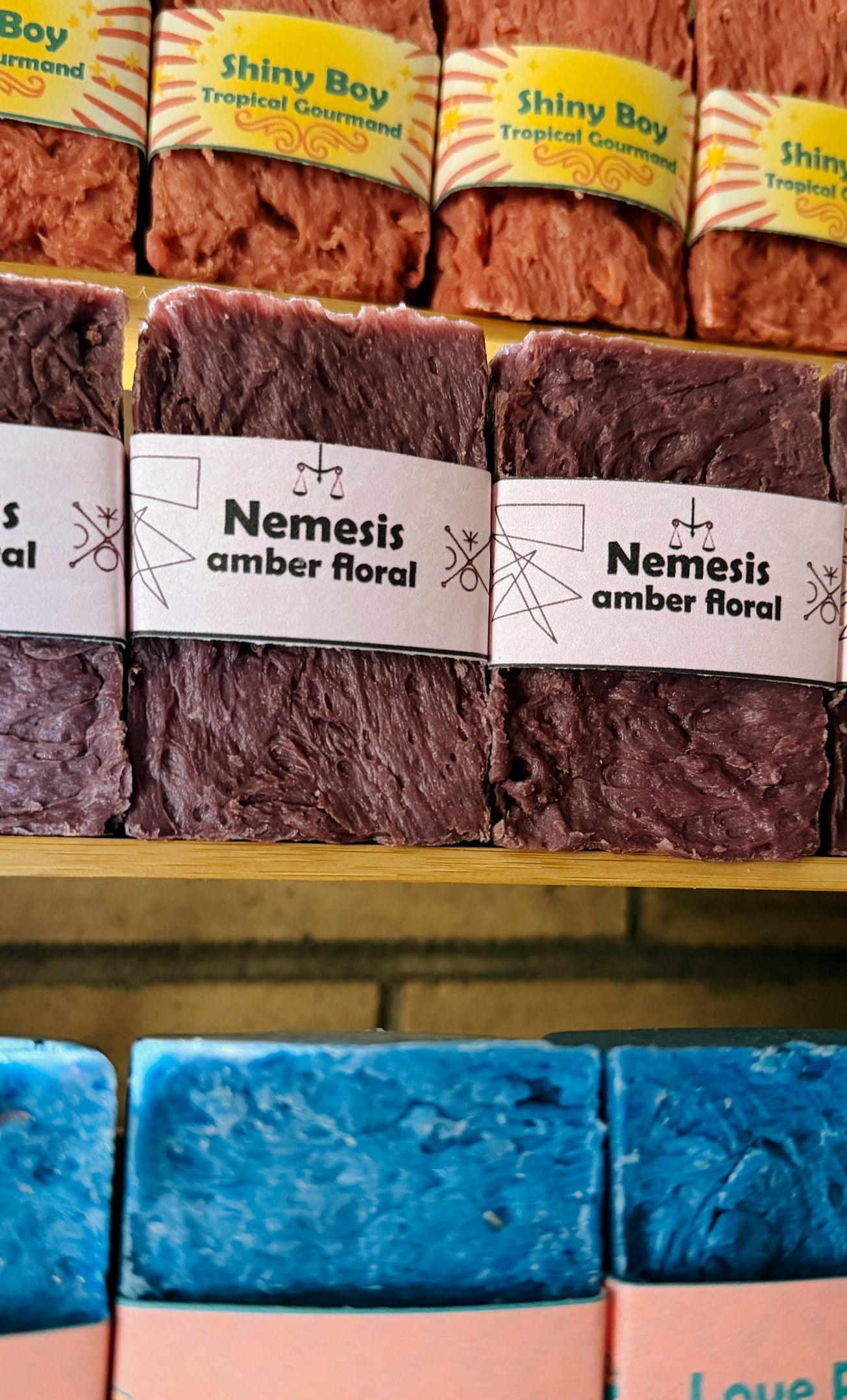 Assorted soap bars with visible branding on a shelf