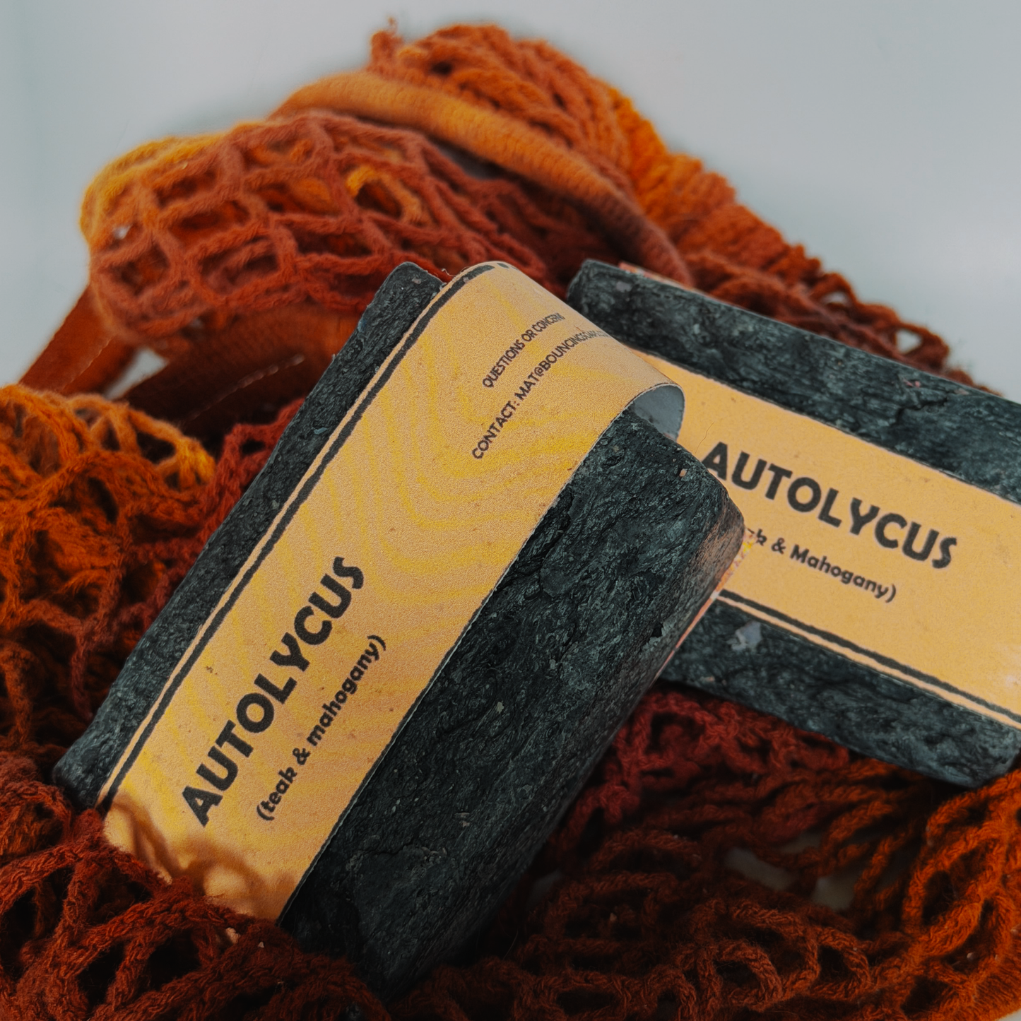 Assorted Bouncing Soaps handmade bar soaps in a red rope basket including black bar of Autolycus soap