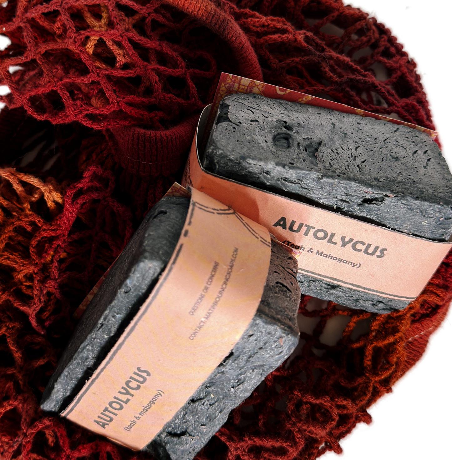 Assorted Bouncing Soaps handmade bar soaps in a red rope basket including black bar of Autolycus soap