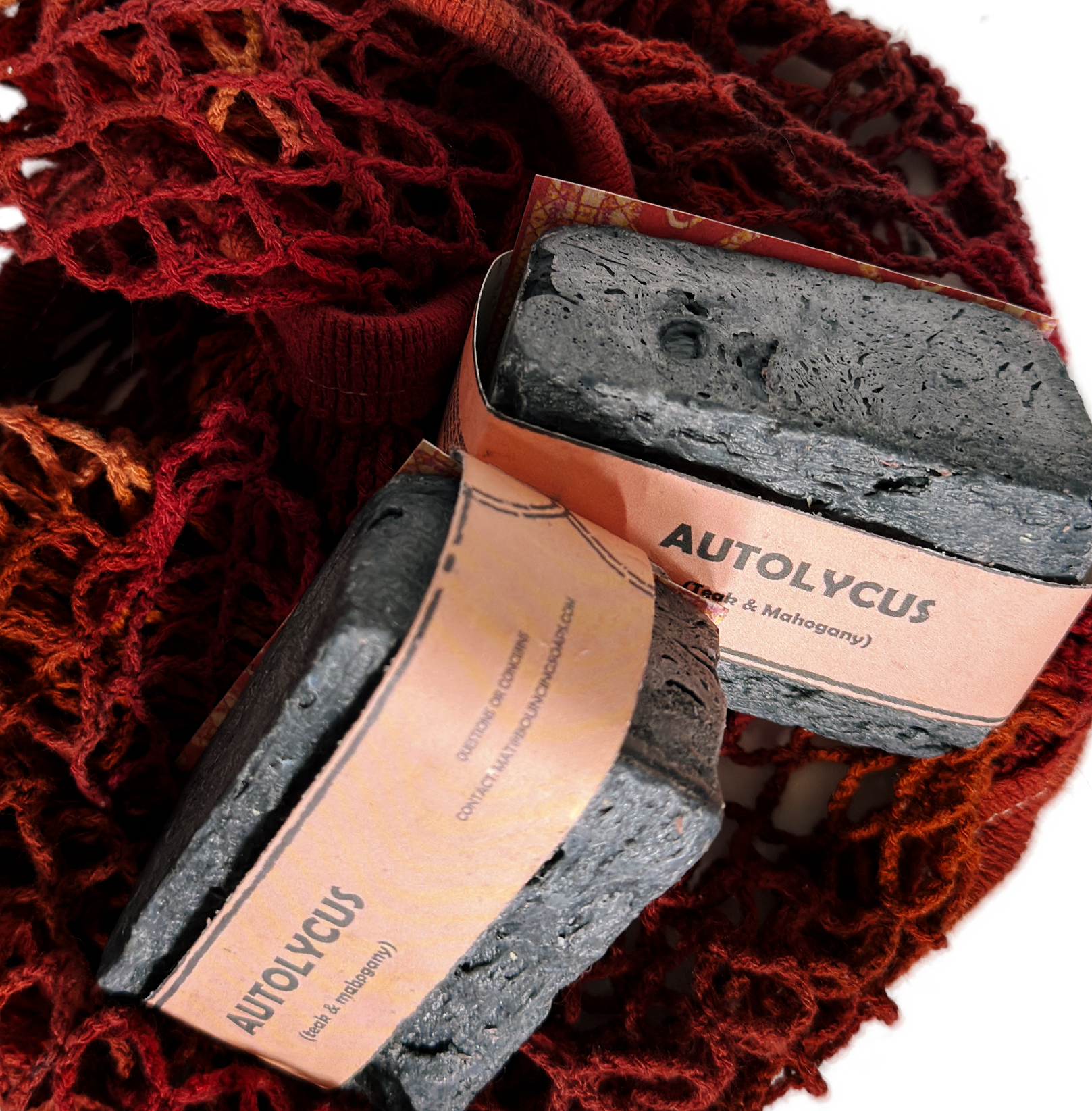 Assorted Bouncing Soaps handmade bar soaps in a red rope basket including black bar of Autolycus soap