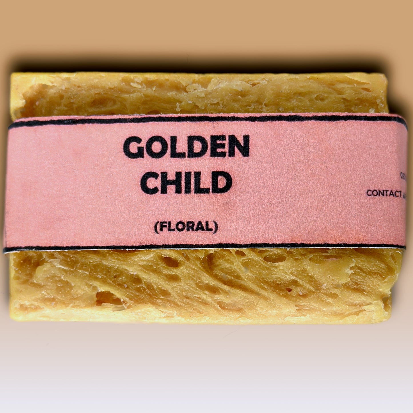 Golden Child floral handmade soap bar by Bouncing Soaps showing golden yellow rustic texture from above on white background