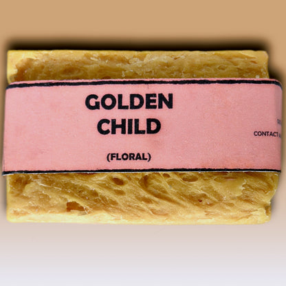 Golden Child floral handmade soap bar by Bouncing Soaps showing golden yellow rustic texture from above on white background